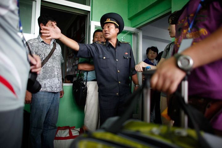 A border officer talks with tourists at the border between China and North Korea in Rason on August 29, 2011. (Photo: Carlos Barria/Reuters)