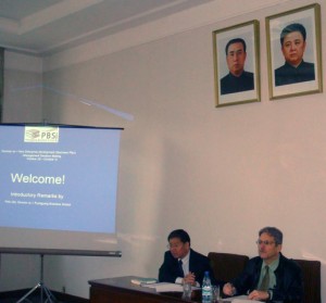 Felix Abt (right) welcomes graduate students to a seminar at the PBS (Pyongyang Business School) under the watchful eyes of the country’s leaders, Kim Jong Il and Kim Il Sung. The slight downward slant in their portraits creates an illusion that their eyes follow you everywhere in the room. (Photo: Felix Abt)