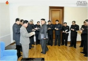 Kim Jong Un gives instructions to the Politburo Members after the enlarged meeting of the Politburo, on December 8, 2013.