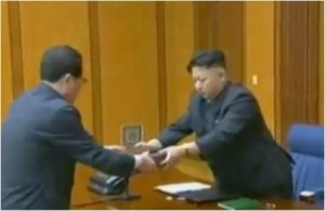 As a sign of special trust, Kim Jong Un presents a handgun with his autographed message to Jang Song Thaek at the enlarged meeting of the WPK Central Military Commission, on February 3, 2013. (KCTV screengrab).