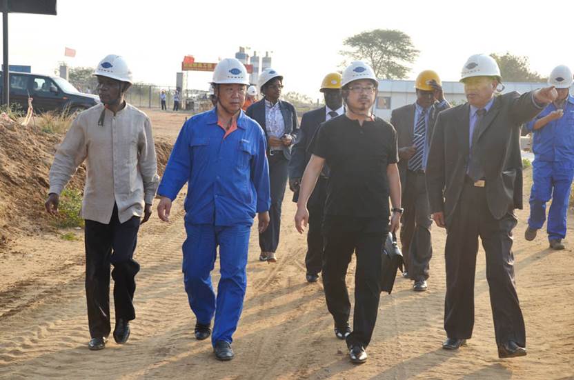 Sam Pa (center right) tours a Queensway project site in Mozambique with Antonio Inacio Junior, Mozambique’s Ambassador to China (far left). Photo: China Chemical Engineering Second Construction Corporation, August 2012.