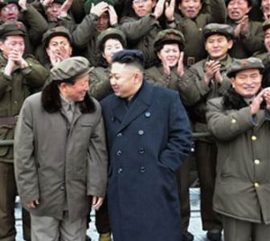 Kim Jong Un talks to Hong Sung Mu at a photo-op with personnel involved in the December 2012 launch of the U’nha-3 (Photo: KCNA).