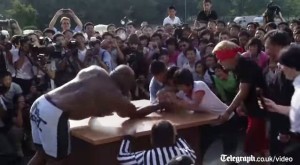 Arm wrestling with North Koreans during the wrestling exhibition in Pyongyang. (Photo: Telegraph UK screengrab)