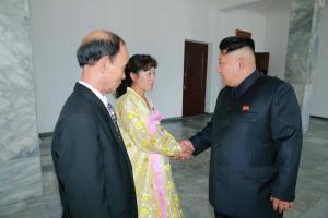 Kim Jong Un talks with two deputy candidates he voted for in the local elections held on July 19, 2015. Photo: DPRK Today. 