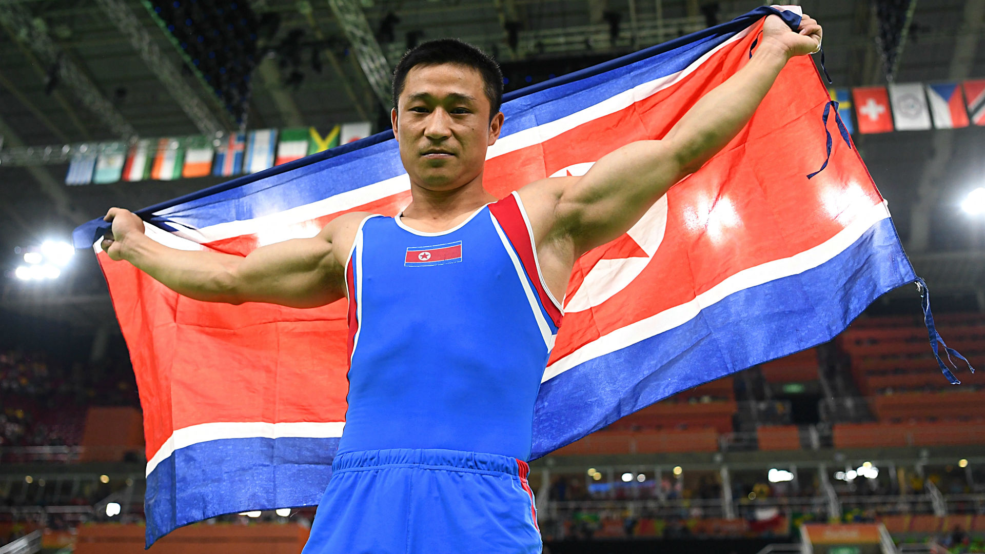 Gymnast and gold medalist Ri Se Gwang holds the North Korean flag at the Olympic Games in Rio de Janeiro, Brazil. (Photo: Laurence Griffiths/Getty)