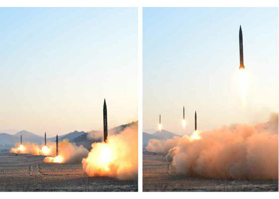 The photo shows to images stitched together: on the left are four ballistic missiles ready to launch, and on the right they are pictured moments later. They are pictured in a field with mountains in the background.