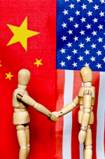 Two artist's figures shaking hands in front of the Chinese and American flags.