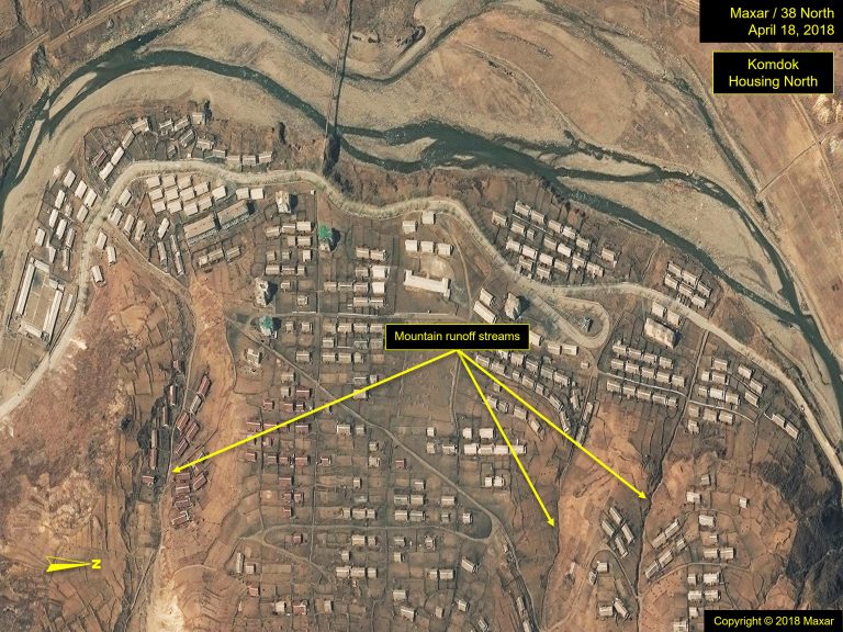 Figure 14a. Komdok Housing South in 2018, showing remnants of flood damage (mud-covered housing). Copyright © 2018 Maxar.