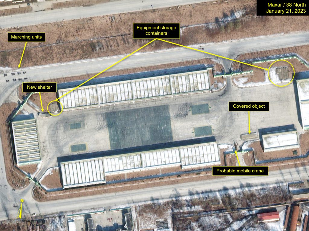 Vehicle tracks and temporary structures observed at the heavy military equipment storage facility.